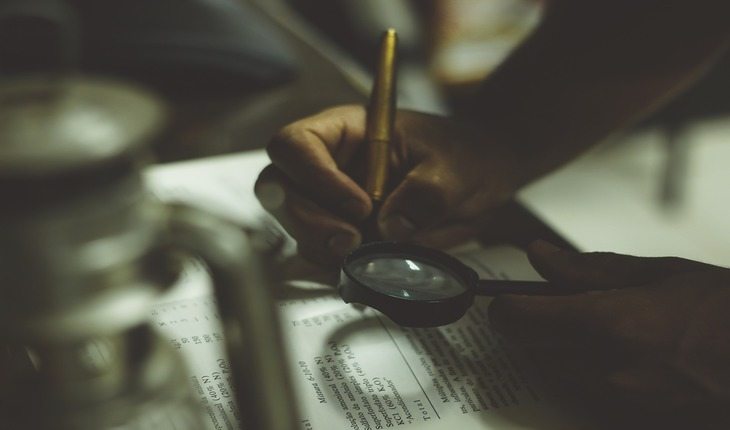 pessoa lendo um livro com uma lupa dicas para-se preparar para uma prova