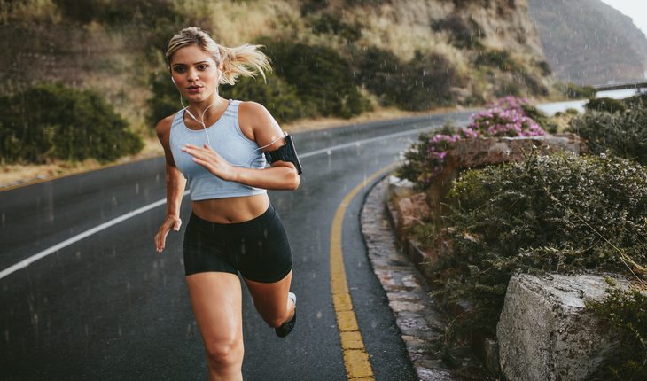 imagem de uma mulher correndo em uma pista. Corrida