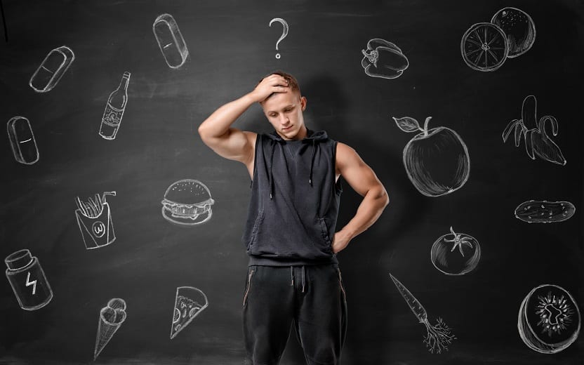 Homem com mão na cabeça, nervoso. Ao fundo, desenhos de alimentos que podem prejudicar a saúde, o deixam indeciso sobre o que consumir